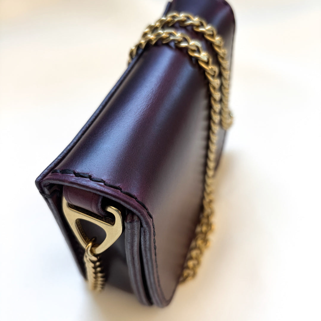 purple leather mini crossbody purse standing angle view