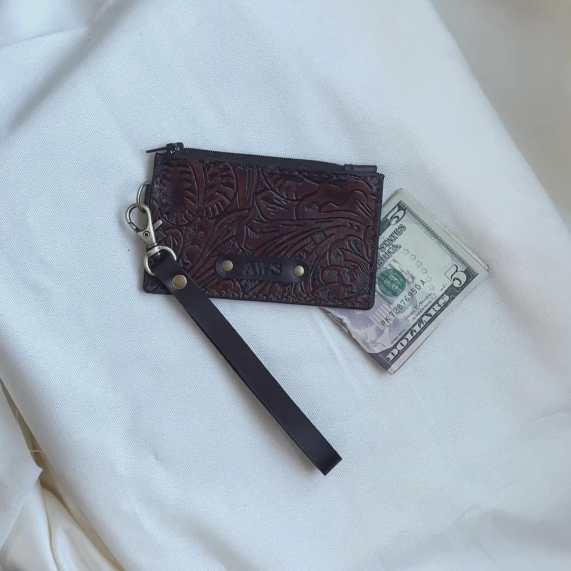 Video of tooled brown zipper wristlet