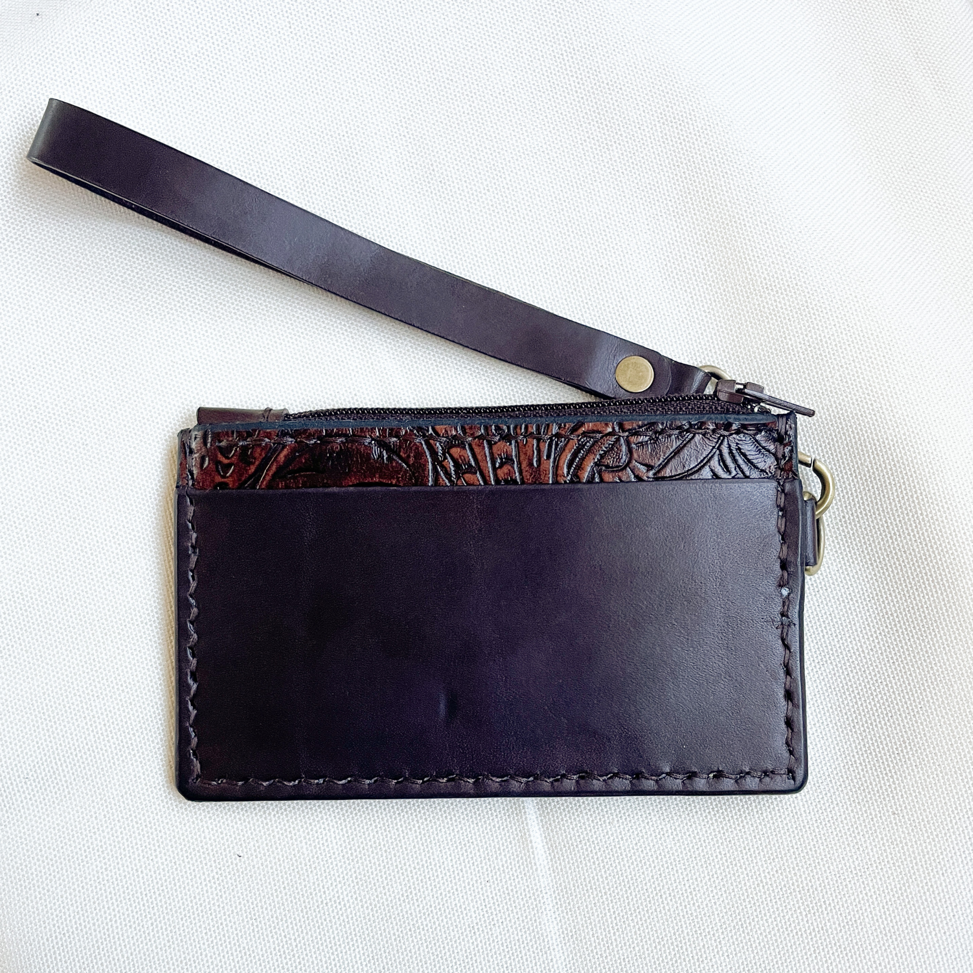 small tooled brown leather wristlet with zipper