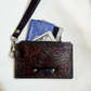 small tooled brown leather wristlet with zipper