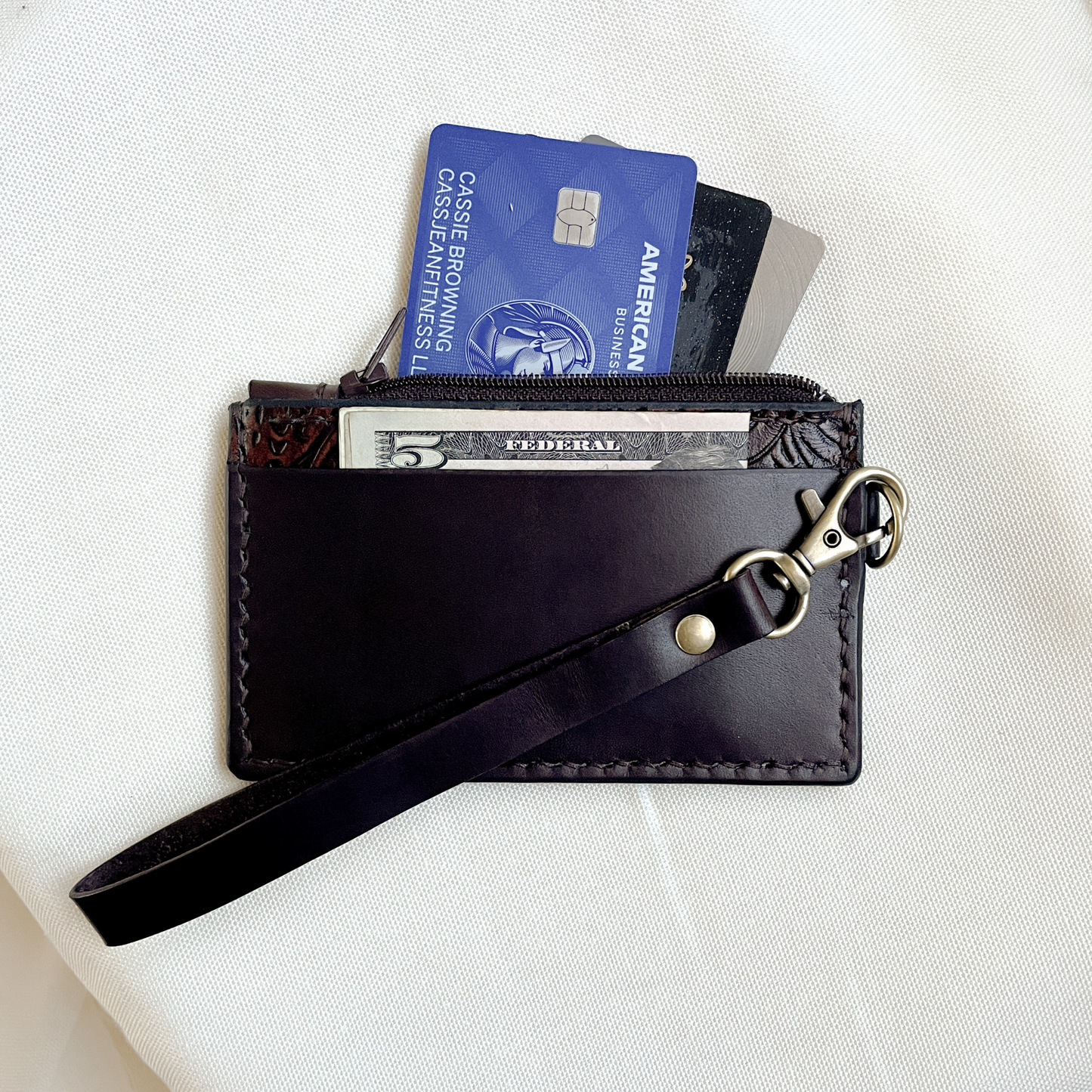 small tooled brown leather wristlet with zipper